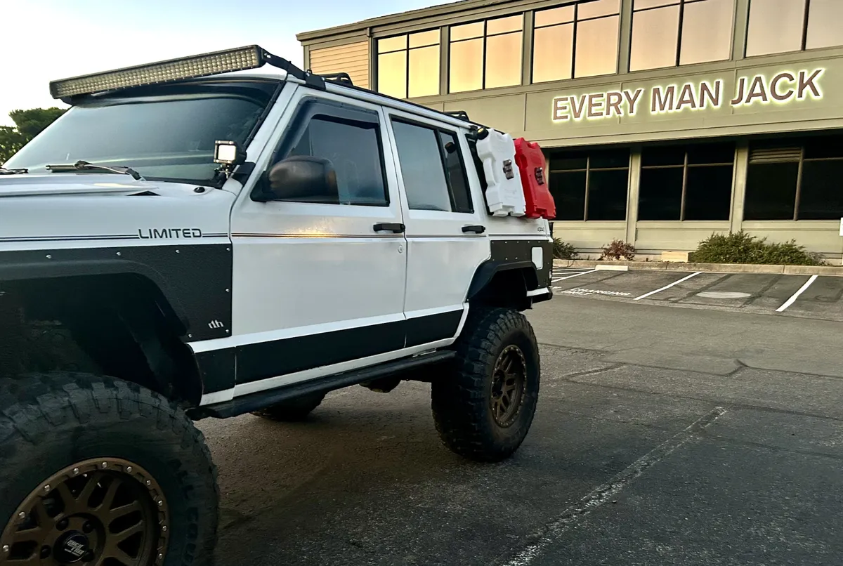 My white XJ Cherokee parked in front of the Every Man Jack office